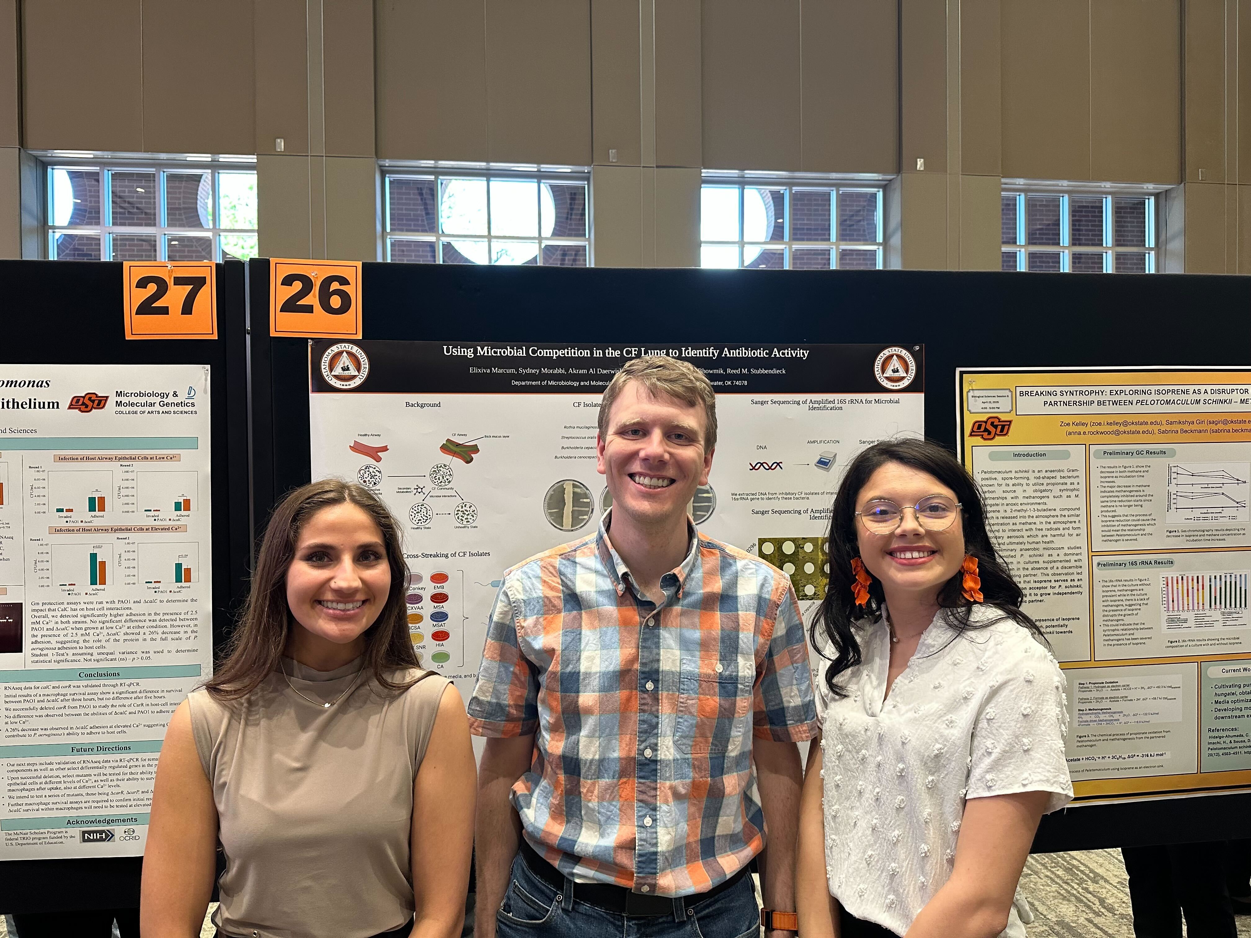 Sydney, Reed, and Elixiva in front of their poster