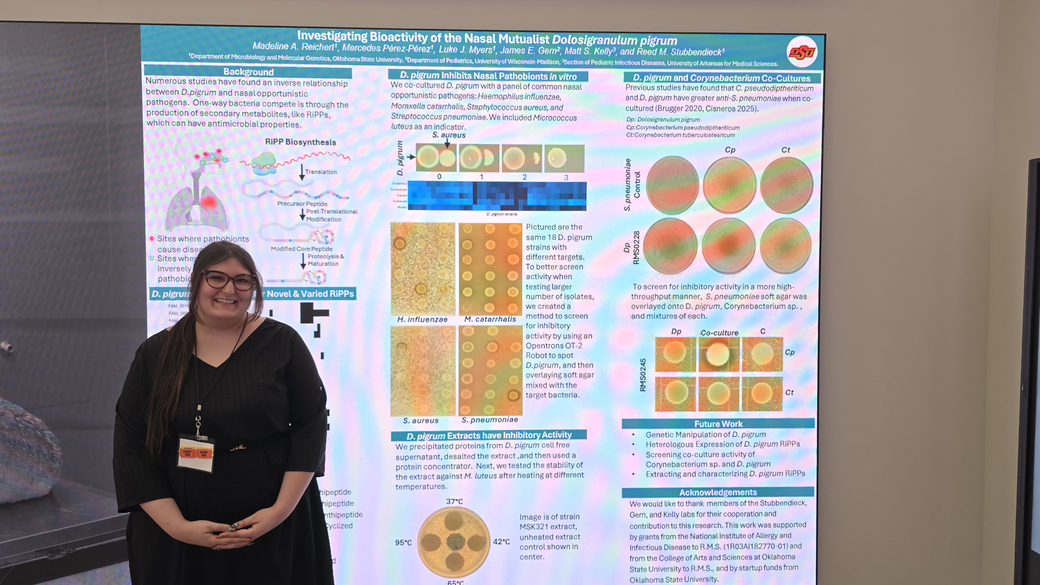 Madeline presenting her poster at the INTERACT Symposium