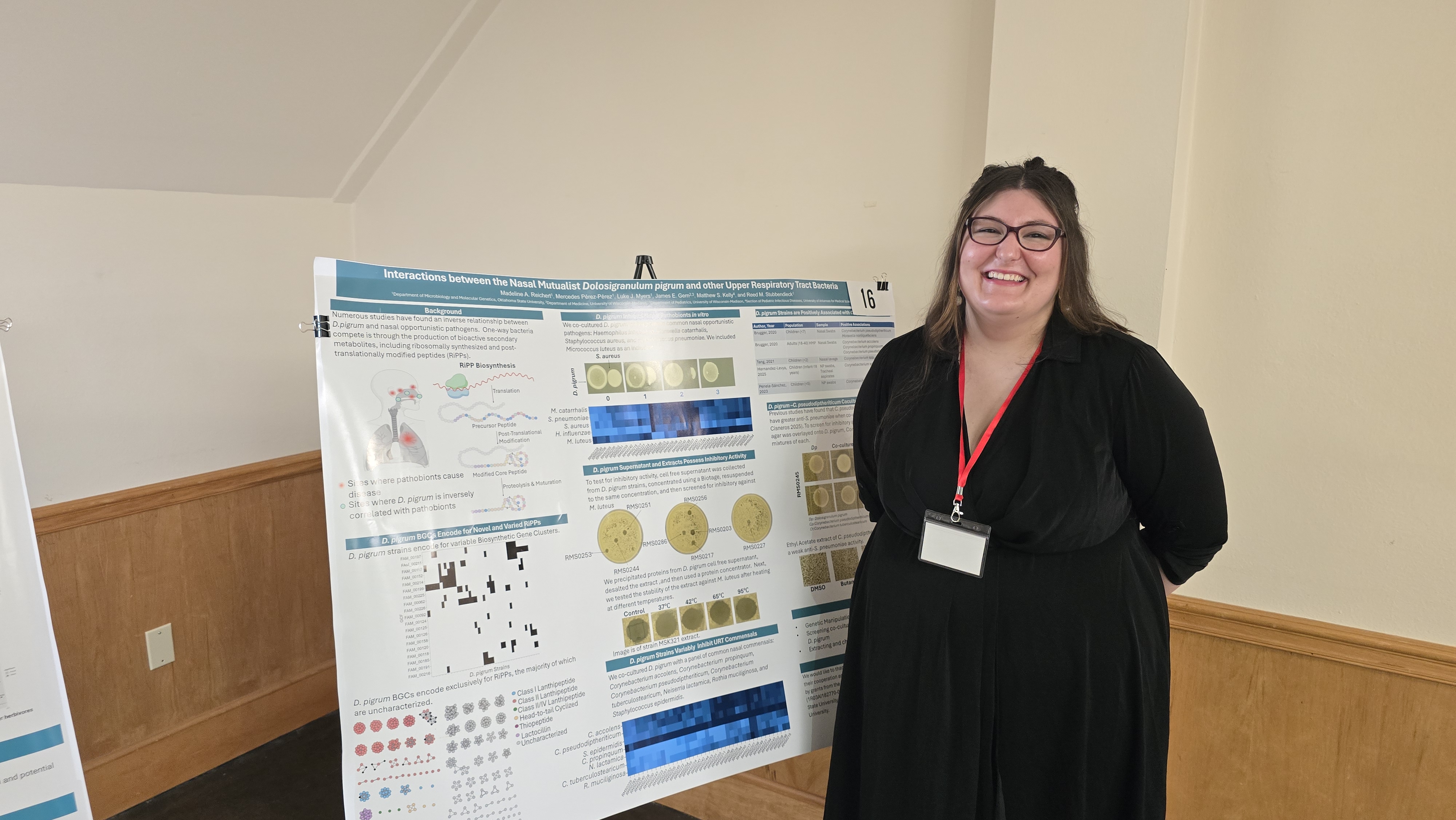 Madeline presenting her poster at the Microbiology and Molecular Genetics Research Symposium