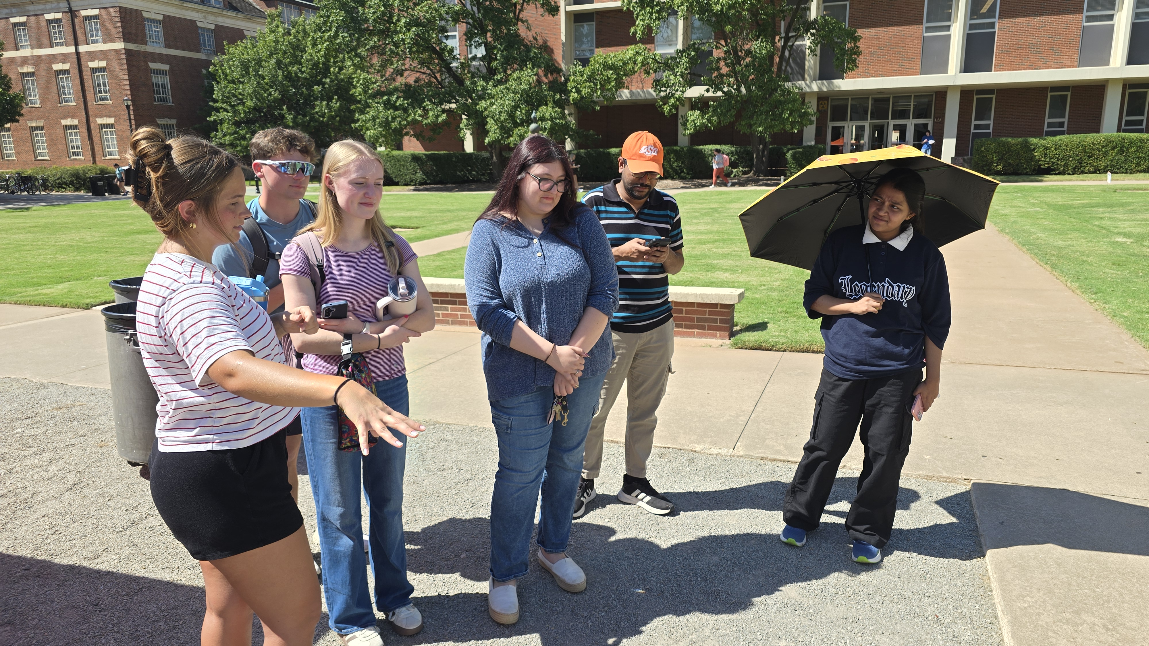Campbell explaining her research project to Alex, Bre, Madeline, Niladri, and Amrin