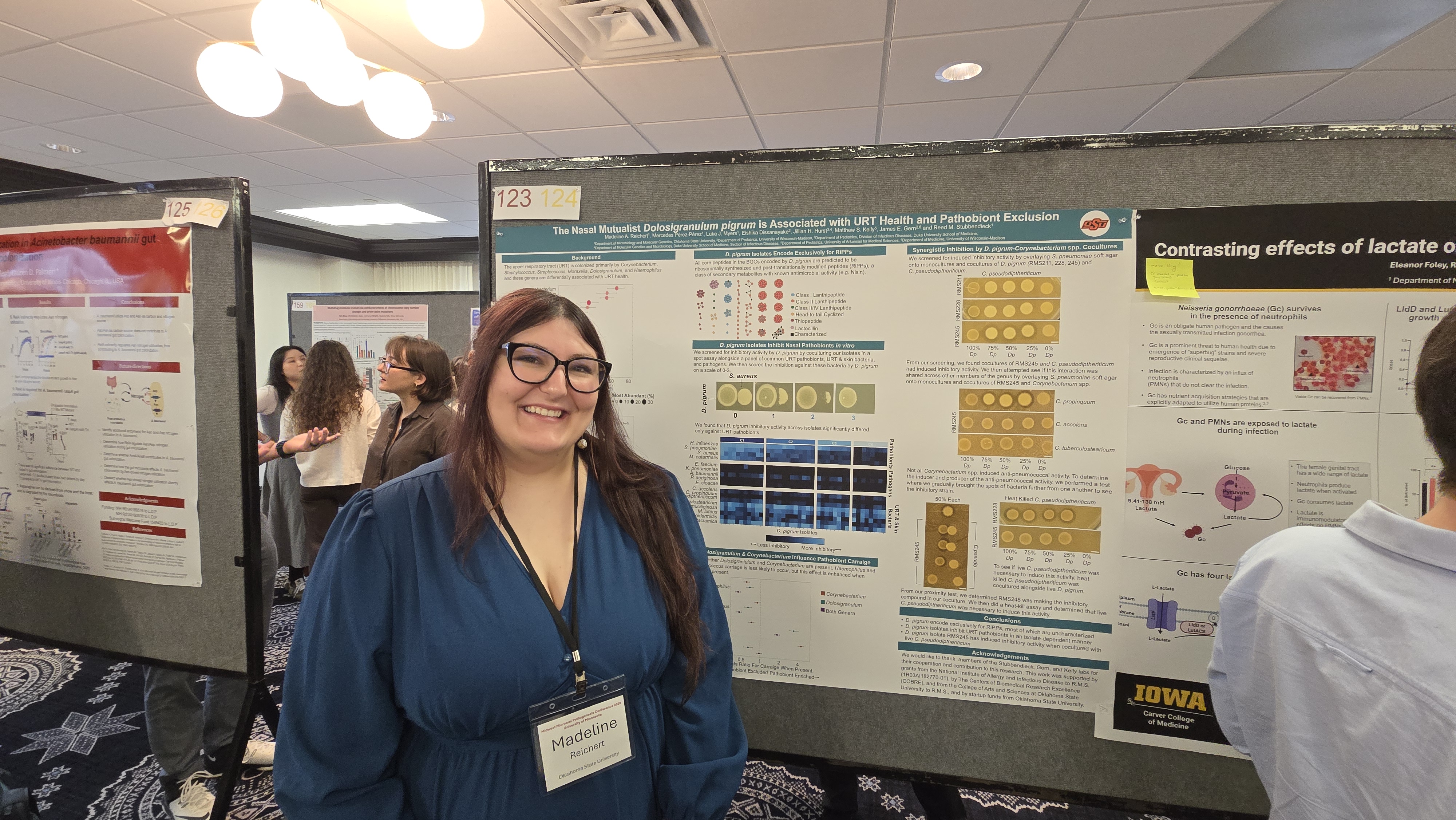 Madeline presenting her poster at the Midwest Microbial Pathogenesis Conference.